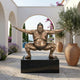 Monumental Contemporary Sumo Wrestler Bronze Sculpture by Giant Sculptures in shiko stance on a black granite base in a Mediterranean archway courtyard.