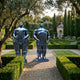 Monumental Contemporary Voluminous Standing Figures Bronze Sculpture in mirror-polished black, paired male and female forms on plinths in a formal hedged garden.