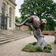 Giant Sculptures Monumental Crouching Cougar Bronze Sculpture, 320cm, poised on a tree stump base with dark patina, set on a stone terrace beside a mansion staircase.