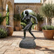 Monumental Female Tennis Player Bronze Sculpture by Giant Sculptures, 220cm, mid-swing pose on inscribed granite plinth in a Mediterranean courtyard.