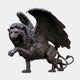 Monumental Heraldic Winged Lion Bronze Sculpture by Giant Sculptures, 450cm, shown rearing and roaring with wings spread wide in dark antique patina on a plain background.
