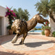 Monumental Leaping Lion Bronze Sculpture by Giant Sculptures, 320cm, shown mid-leap with golden-brown patina on a circular paved terrace beside a pool.