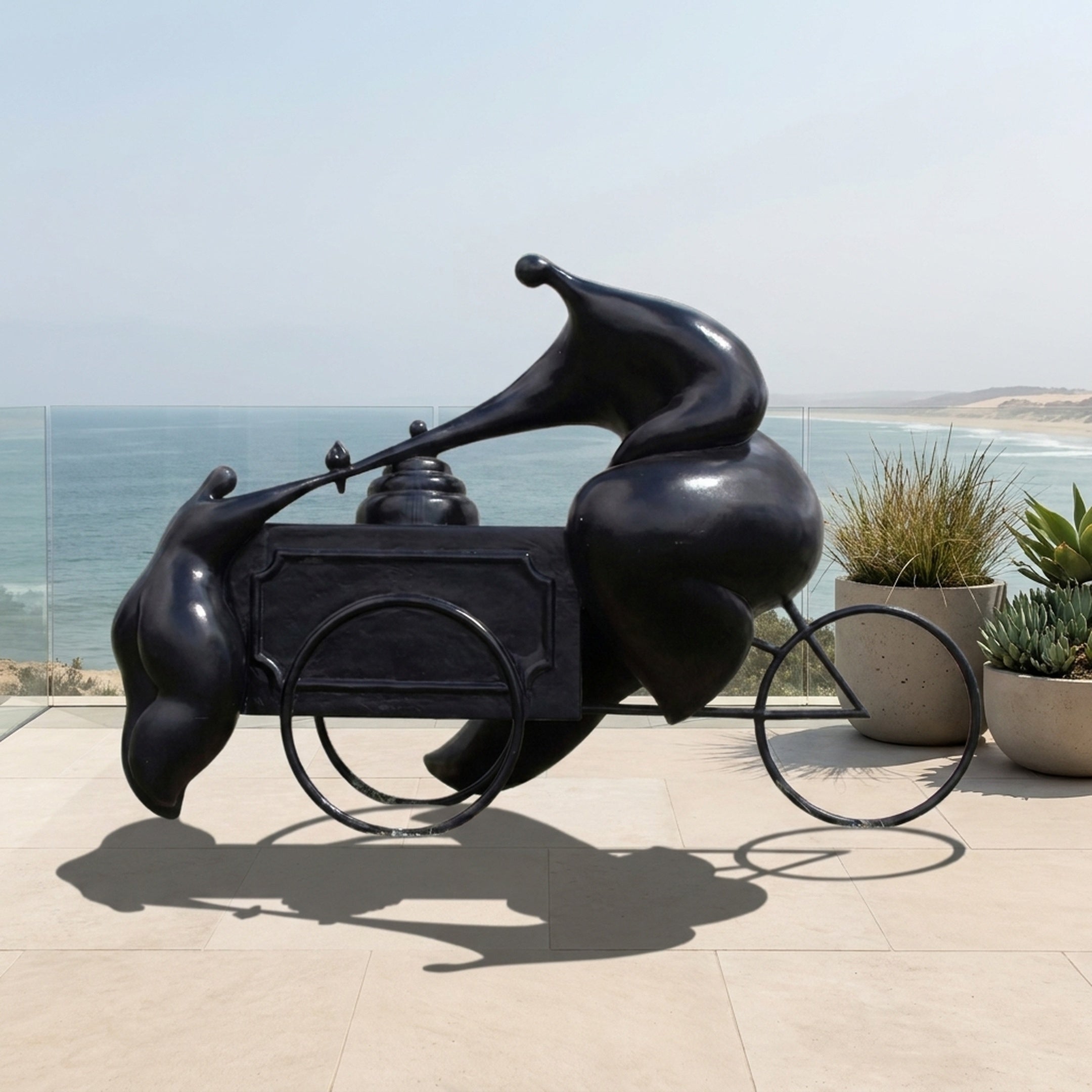 Monumental Modern Abstract Figure and Ice Cream Cart Bronze Sculpture by Giant Sculptures in black patina, displayed on an oceanfront terrace beside potted succulents.