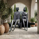 Monumental Modern Abstract Seated Figures Bronze Sculpture by Giant Sculptures, two 220cm dark patinated figures on a bench beneath a stone archway with olive trees.