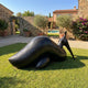 Monumental Modern Reclining Female Figure Bronze Sculpture in dark patina on a lawn beside a pool, stone walls, olive trees, and a terracotta villa.