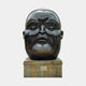 Monumental Oversized Human Head Bronze Sculpture by Giant Sculptures in high-gloss black patina, front view on a low stone plinth against a plain background.
