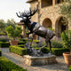 Monumental Rearing Bull Moose Bronze Sculpture by Giant Sculptures on a stone plinth in a Tuscan garden with lavender, lemon trees, and stone villa.