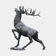 Monumental Rearing Stag Bronze Sculpture by Giant Sculptures shown in side view, rising on hind legs with antlers raised and dark patina, on a rock base.