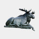 Giant Sculptures' Monumental Reclining Moose Bronze Sculpture in dark green-black patina, shown in side profile with legs tucked and broad palmate antlers raised.