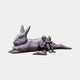 Monumental Reclining Rabbit and Child Reading Bronze Sculpture by Giant Sculptures, 180cm, dark patina, with a small rabbit and child reading at its side.