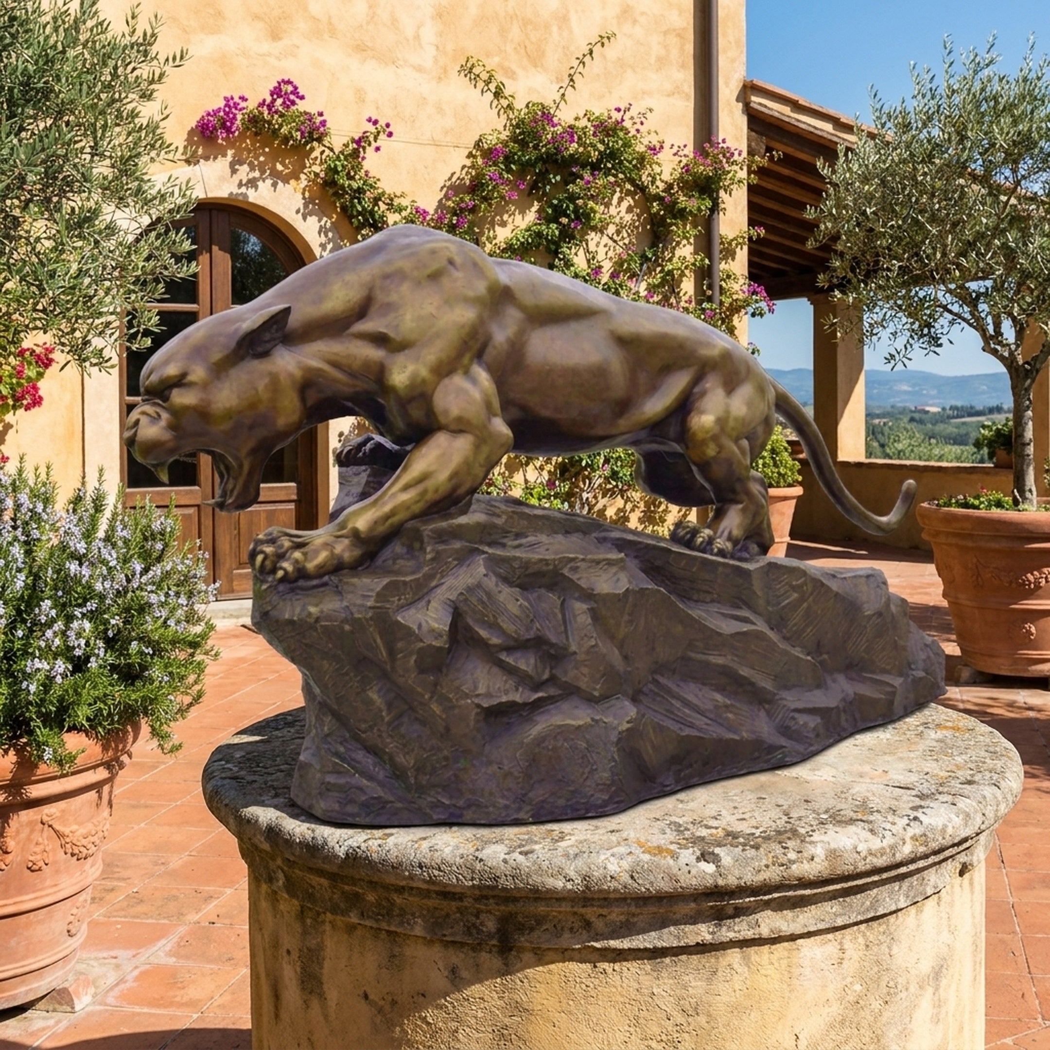Monumental Roaring Panther Bronze Sculpture by Giant Sculptures displayed on a stone plinth outside a Tuscan villa, crouched mid-roar on its rocky base.