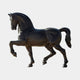 Monumental Striding Horse Bronze Sculpture by Giant Sculptures, 280cm, side view with raised front leg and dark brown-black patina on a plain background.