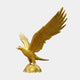 Monumental Traditional Bald Eagle Bronze Sculpture in gold finish, wings raised, beak open, perched on a rocky base, shown against a plain light background.