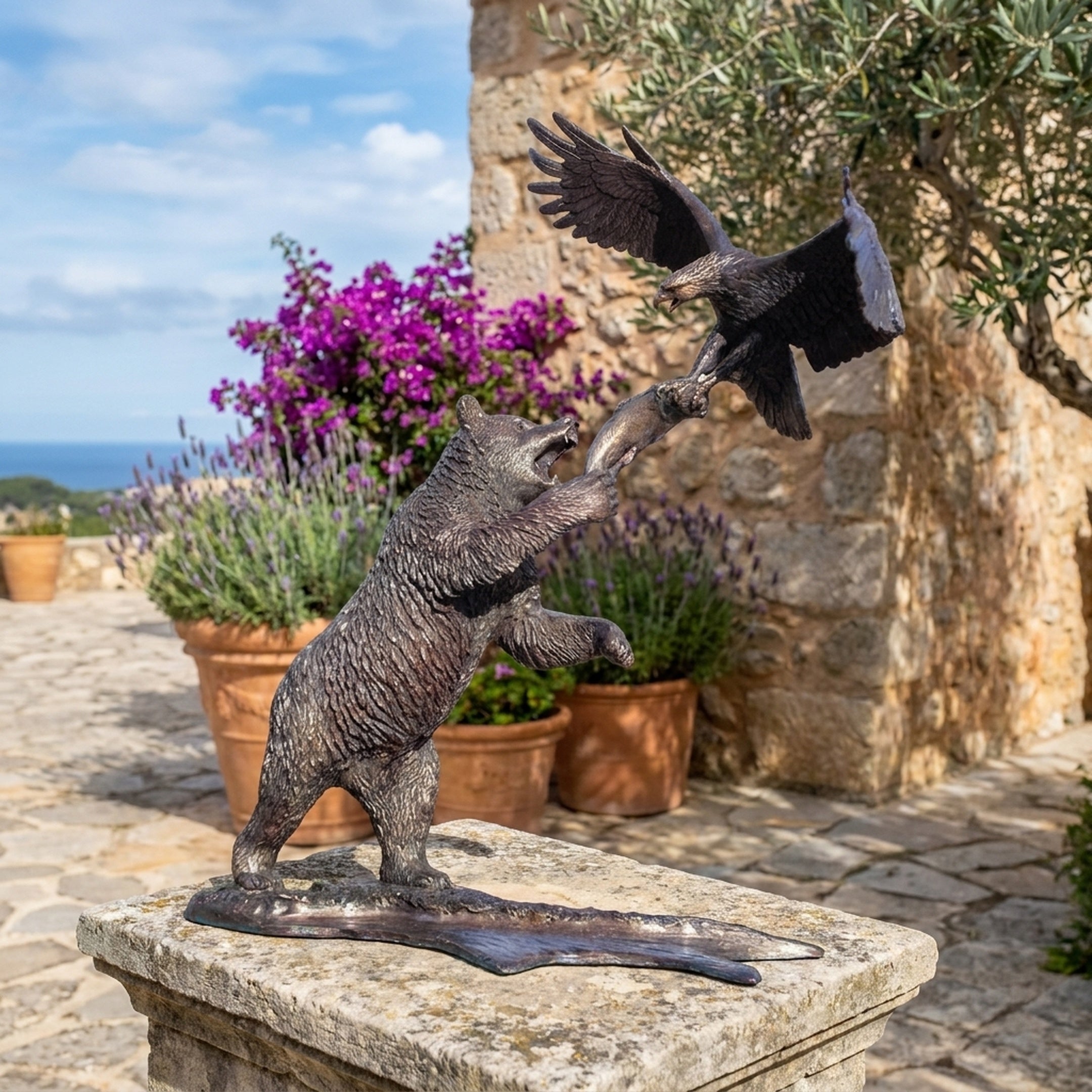 Monumental Traditional Bear and Eagle Bronze Sculpture by Giant Sculptures on a stone plinth, bear rearing to meet a descending eagle over a fish, garden setting.
