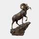Monumental Traditional Bighorn Ram Bronze Sculpture by Giant Sculptures, rearing on a jagged rock base with curled golden horns and dark brown patina.