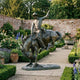 Monumental Traditional Cowboy and Bucking Bronco Bronze Sculpture by Giant Sculptures, 320cm, displayed on a stone path in a walled garden with lavender and roses.