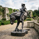 Monumental Traditional Cowboy Riding Rearing Horse Bronze Sculpture by Giant Sculptures, 300cm dark patina figure on guitar-shaped base in a formal garden.