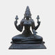 Monumental Traditional Four-Armed Goddess Bronze Statue by Giant Sculptures, seated in padmasana with dark patina, holding lamps and varada-abhaya mudras, on white.