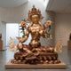 Monumental Traditional Green Tara Goddess Bronze Sculpture by Giant Sculptures, 300cm, seated in royal ease on a tiered lotus throne in a gallery setting.