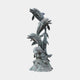 Giant Sculptures Monumental Traditional Leaping Dolphins Bronze Fountain in verdigris patina, four dolphins spiralling upward from a reef base, plain background.