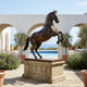 Monumental Traditional Rearing Horse Bronze Sculpture by Giant Sculptures, dark brown patina, on stone plinth in an arched poolside courtyard overlooking the sea.