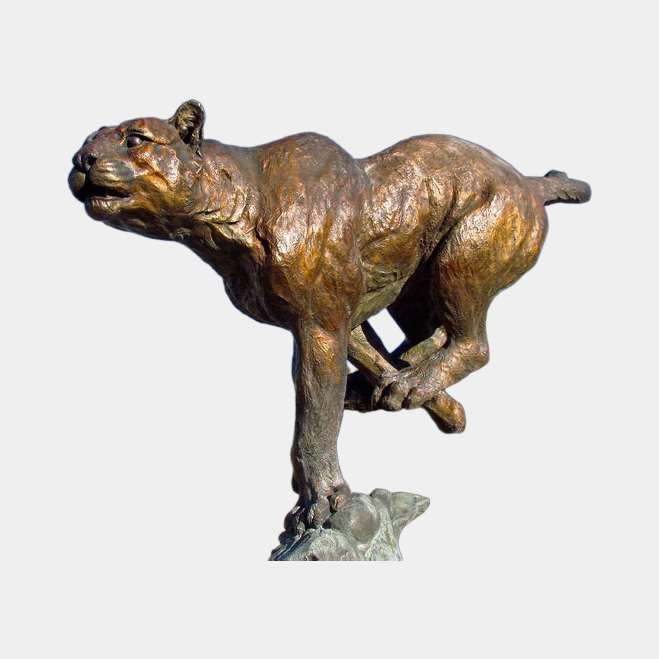 Monumental Traditional Running Cougar Bronze Sculpture by Giant Sculptures, shown mid-sprint in side profile with reddish-brown patina on a rocky base.