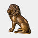 Monumental Traditional Seated Lion Bronze Sculpture by Giant Sculptures in warm golden-brown patina, shown in side profile with detailed flowing mane on a plain background.