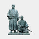 Monumental Traditional Standing and Seated Samurai Bronze Sculpture by Giant Sculptures, two robed figures with swords, blue-grey verdigris patina, plain background.
