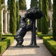 Monumental Traditional Standing Bear and Strawberry Tree Bronze Sculpture by Giant Sculptures on a gravel path lined with cypress trees and hedges.