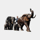 Monumental Trumpeting Elephant Herd Bronze Sculpture by Giant Sculptures, two adults and two calves in dark antique patina, shown beside a man for 330cm scale.