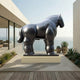 Monumental Voluminous Standing Horse Bronze Sculpture by Giant Sculptures in deep black-brown patina, displayed on a low plinth on an oceanfront terrace.
