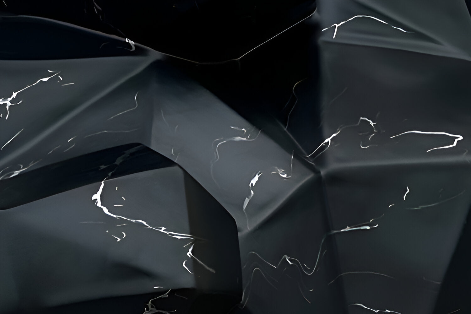 Abstract image featuring dark, angular, and faceted surfaces with smooth textures. White streaks and lines accentuate the shapes, creating a dynamic and modern appearance.