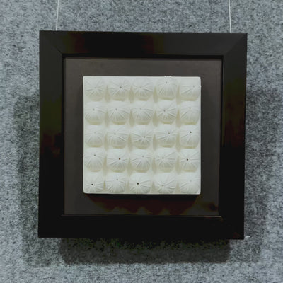 Showcase of the Harmonia 3D Floral Grid Sculpture, featuring rows of sculpted ceramic blooms with pleated detailing, framed in matte black over a dark backdrop.