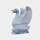 The Wings-Lifted Swan II Marble Outdoor Sculpture by Giant Sculptures features hand-carved blue accents, wings raised and beak open, standing elegantly on a rectangular base. Height: 120cm.