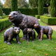 Traditional Bear Family Bronze Sculpture by Giant Sculptures with an adult bear and three walking cubs in dark copper-brown patina on a garden lawn.