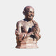 Giant Sculptures Traditional Bespectacled Elder Bust in reddish-brown cast bronze, hands in namaste, on a two-tiered stone plinth against a light grey background.