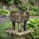 Giant Sculptures 30cm Traditional Chinese Ding Vessel bronze tripod cauldron with taotie reliefs and gold inlay, displayed on a stone plinth among lavender and ferns.