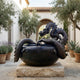 Traditional Chinese Dragon and Cauldron Bronze Fountain by Giant Sculptures, dark patina dragon coiled around a lotus-decorated cauldron on a stone plinth in a Mediterranean courtyard.