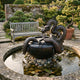 Traditional Chinese Dragon and Cauldron Bronze Fountain by Giant Sculptures, with the dragon coiled around a lotus-decorated bowl in a walled garden beside a weathered wooden bench.