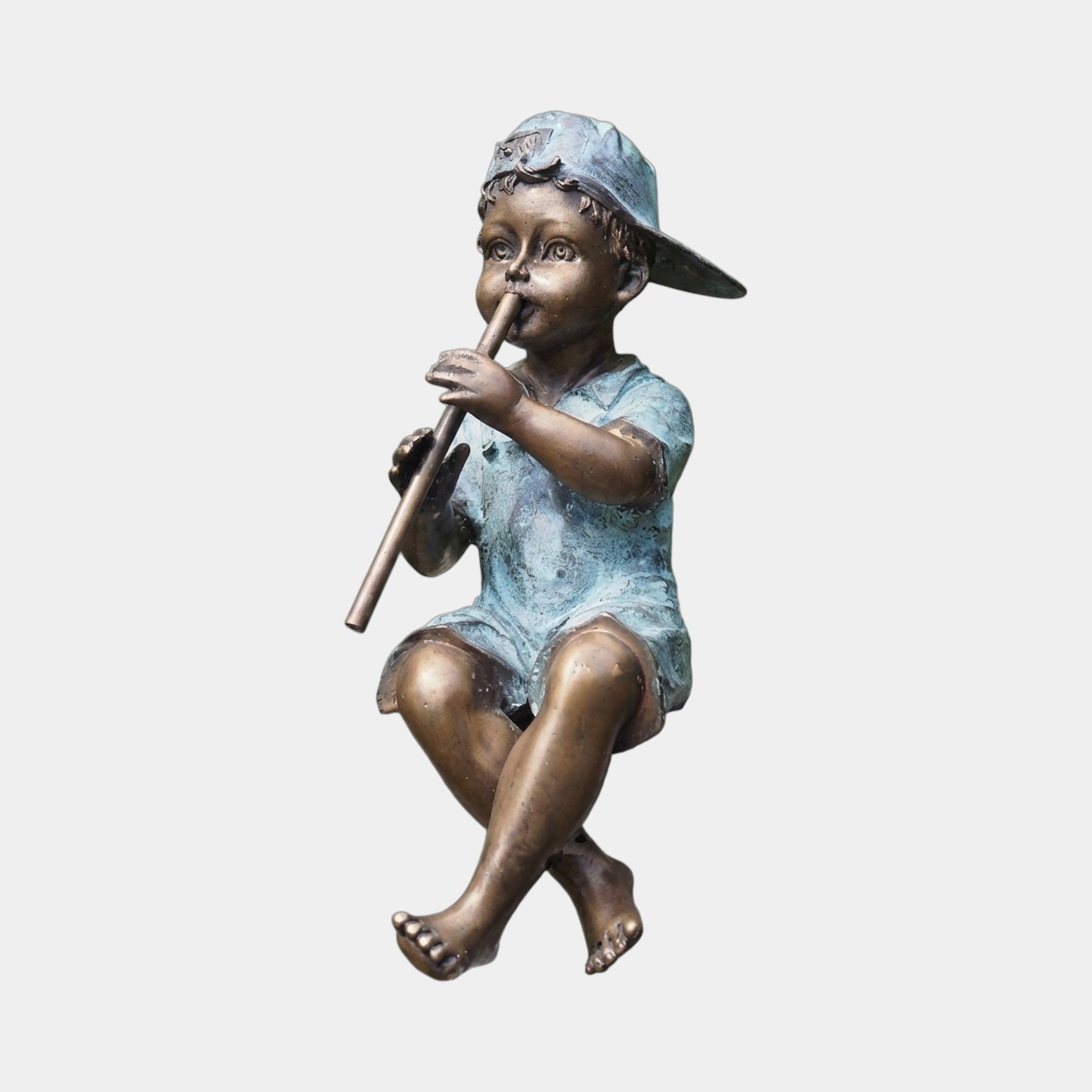 Traditional Flute Boy Bronze Fountain by Giant Sculptures, a 90cm seated barefoot boy in backward cap and shirt playing a flute, two-tone bronze and verdigris patina.