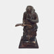 Traditional Reading Monkey Bronze Sculpture by Giant Sculptures, shown front-on with the chimpanzee hunched over an open book atop stacked volumes, on a plain background.